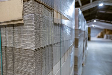 Photo for Folding cardboard boxes. Perforated sheets of corrugated cardboard a stack on pallets. Packaging of finished products in industrial production. - Royalty Free Image