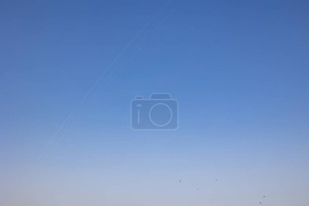 Photo for KYIV, UKRAINE - MAY 29 2023: work a surface-to-air missile (SAM) system. A missile trace and missile at flight, in the sky over the city after a Russian missile strike, amid Russia's attack - Royalty Free Image