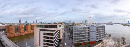 Photo for Hamburg, Germany - Feb 21 2020: panoramic cityscape view of Hamburg, Germany. On foreground the Harbor District (HafenCity) and the Sandtorkai the Kaiserkai streets. - Royalty Free Image