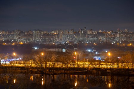 Photo for Night cityscape of the big city. Bright, multi colored light on empty streets. Apartment buildings in bedroom town area. Kyiv in end of march 2024. Ukraine. - Royalty Free Image
