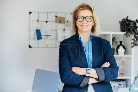 Portrait of smiling 50s stylish, confident mature businesswoman, middle aged company ceo director, experienced senior female professional, business coach team leader in modern office. Female leader.