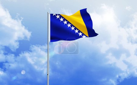 The flag of Bosnia and Herzegovina waving on the shiny blue sky