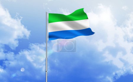 The flag of Sierra Leone waving on the shiny blue sky