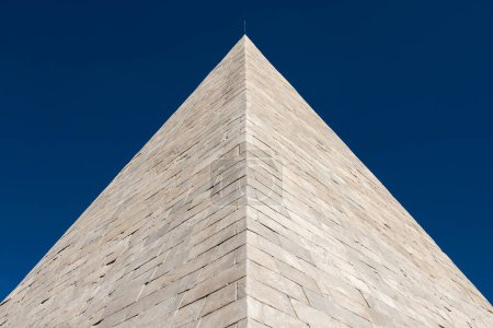 Photo for White marble Pyramid of Cestius, now part of Rome ancient walls, erected in the 1st century BC - Royalty Free Image