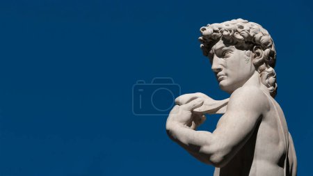 Photo for Michelangelo's David, a masterpiece of sculpture symbol of Italian Renaissance. Outdoor replica in Florence (with blue sky and copy space) - Royalty Free Image