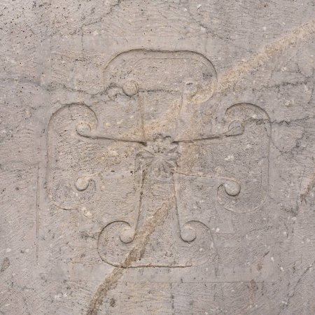 Ancient spirituality and religion. Medieval carved cross on a wall