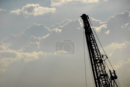Port crane silhouette with clouds