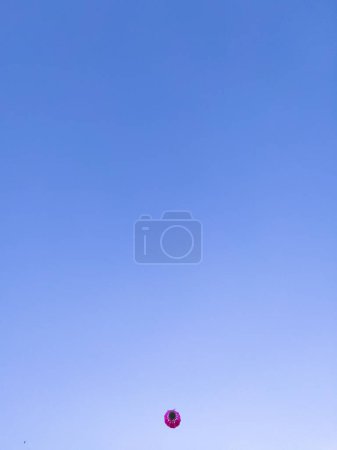 Photo for Pink badminton shuttlecock in blue sky. Outdoor sports and recreation concept. Badminton equipment. Clear sky and sport - Royalty Free Image