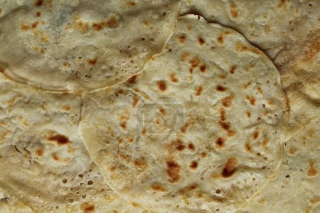 Thin pancakes made from wheat flour fixed with a close-up photo shooting. View from above.