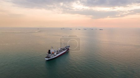 Photo for Ship logistic industry sailing in sea at evening sky aerial view - Royalty Free Image