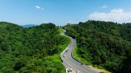 aerial view drone shot ROAD No.1081 or shape number three of winding mountain road between Pua District, Nan Province, Thailand is highlight point and landmark that tourist like to take pictures of because of the beauty of the road