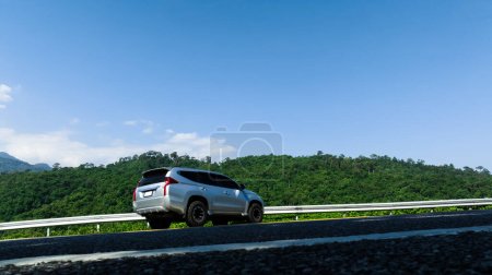 off-road vehicle side view wide angle shot on the road, mountain blue sky  background, travel toirist concept,