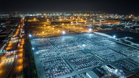 Photo for Night scene shot over lighting new cars lined up at Industrial factory and commercial port background aeriail view - Royalty Free Image