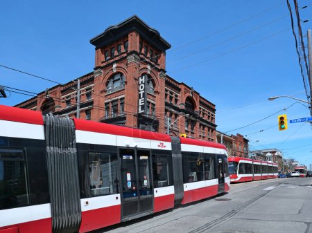 Photo for Modern Toronto streetcars in front of a historic 19th century hotel - Royalty Free Image