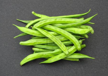 Fresh Guar or cluster beans on black background 