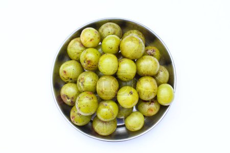 Indian gooseberry or Phyllanthus emblica in a plate on white background top view 