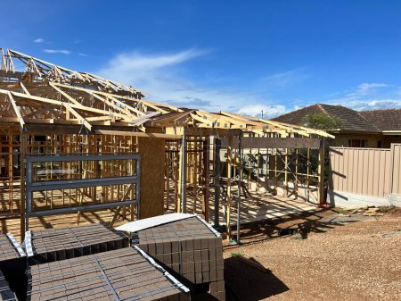 Photo for New residential construction home framing against a blue sky. High quality photo - Royalty Free Image