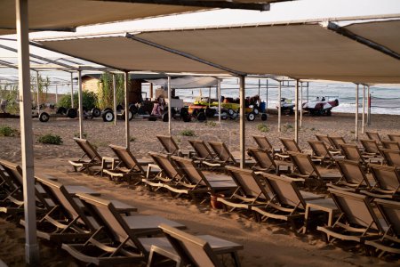 Rows of beach loungers by the sea, promoting resorts, beach tours, products/services, and beachside activities and entertainment.