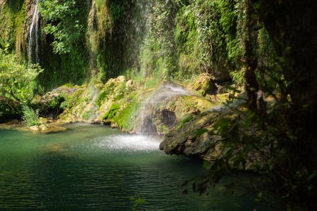 Discover nature's wonders: a waterfall in lush green park. Ideal for eco-tourism, hiking excursions, and exploring natural reserves and landmarks.