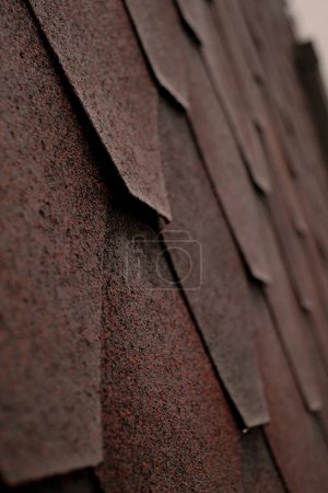 A close-up of red shingle roof, emphasizing waterproofing and leak repair. Highlight your company's assurance of reliable home protection from moisture and roof waterproofing.