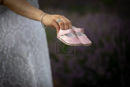 Photo for Close up of pink baby shoes in a gender reveal situation. Discovery of a daughter - Royalty Free Image