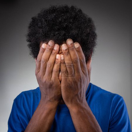 Photo for A powerful portrayal of a person covering their face with their hands, capturing a moment of sadness, grief, or shame - Royalty Free Image