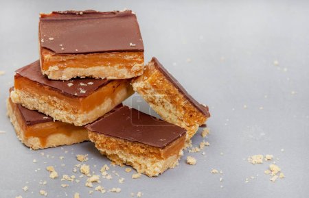 Rustic style millionaires shortbread blocks with crumbs