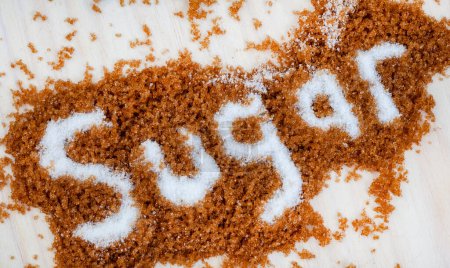 Photo for Sugar written in white sugar on brown sugar - Royalty Free Image
