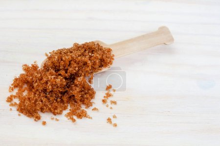 Photo for Wooden scoop with muscovado or brown sugar - Royalty Free Image