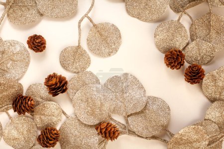 Photo for Christmas Border of gold leaves and pinecones on white - Royalty Free Image