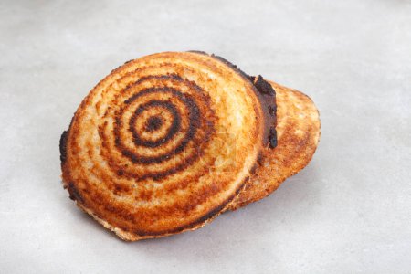Photo for Jaffle, an old school toasted sandwich, filled with savory mince. Grey backdrop, copy space - Royalty Free Image