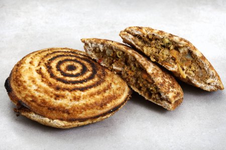Photo for Jaffle, an old school toasted sandwich, filled with savory mince. Grey backdrop, copy space - Royalty Free Image