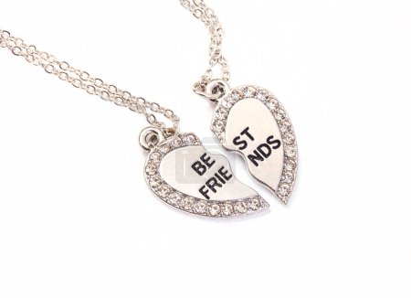 Photo for Broken heart best friend necklace, in silver on white background and copy space - Royalty Free Image