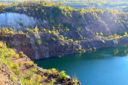 Old abandoned granite quarry full with greenish color water. Radon Lake, located in Ukraine, Migeia. Former granite quarry