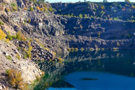Old abandoned granite quarry full with greenish color water. Radon Lake, located in Ukraine, Migeia. Former granite quarry