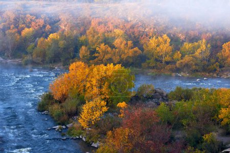 View of Southern Bug River and rocks at calm autumn morning in reserve Buzsky Gard, Migeya, Mykolaiv region, Ukraine. View from above