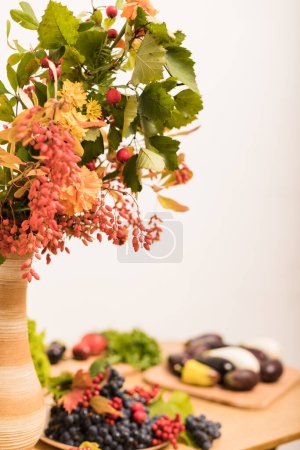 Photo for Autumn composition vase, berries, fruits, vegetables on the table in the kitchen. High quality photo - Royalty Free Image