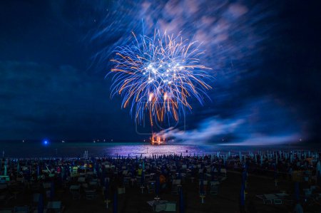 Photo for Fireworks in the night sky over the sea near Lignano Sabbiadoro, Italy - Royalty Free Image