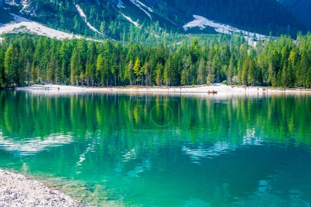 Photo for Dolomites. Braies lake and boats. Emerald colors on the water. - Royalty Free Image