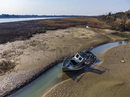 Photo for Aerial view of abandoned ship at lagoon and mouth. - Royalty Free Image