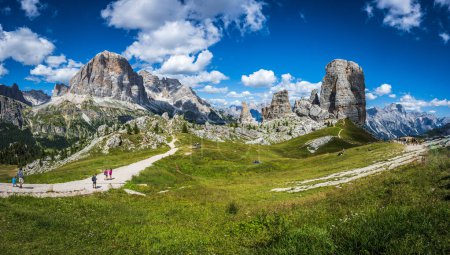 Photo for August 9, 2022: Tourists walks at Central Dolomites. Monuments of nature. Averau, Nuvolau and five towers. Cortina d'Ampezzo. - Royalty Free Image