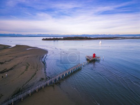 The beach of Lignano Sabbiadoro and its historic lighthouses.