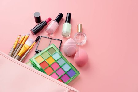 Photo for Bright summer eyeshadow palette and makeup products in pink cosmetic bag on pink background. Makeup cosmetics. Colorful colors. Place for text. Flat lay. Top view. layout - Royalty Free Image