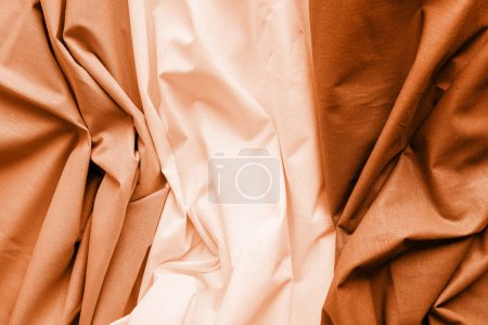 Foto de Color del año 2024: Melocotón Fuzz. Primer plano de tela de seda blanca, gris y marrón ondulada. Fondo de textura abstracta - Imagen libre de derechos