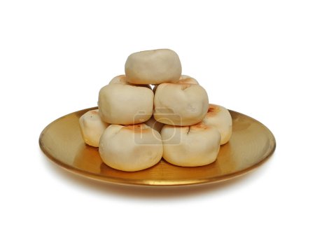 Pile of Bakpia Pathuk served on a golden plate isolated on white background with clipping path. Chinese-influenced Indonesian traditional snacks stuffed with mung beans. Food souvenir of Yogyakarta.