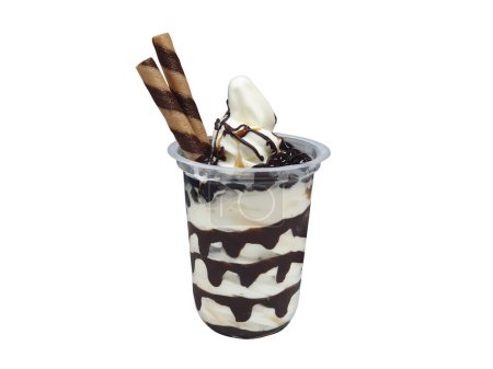 Sundae ice cream in a clear plastic cup isolated on white background with clipping path. Blank no label mock up template. Vanilla soft serve ice cream with chocolate sauce topping, wafer roll sticks.