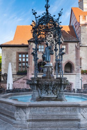 Photo for Gaenseliesel fountain with the old town hall in the background, the landmark of Goettingen. More pictures from Goettingen in my collection - Royalty Free Image
