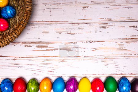 Photo for Tabletop easter theme with copy space. Colorful easter eggs with basket . More Easter motifs in my collection - Royalty Free Image