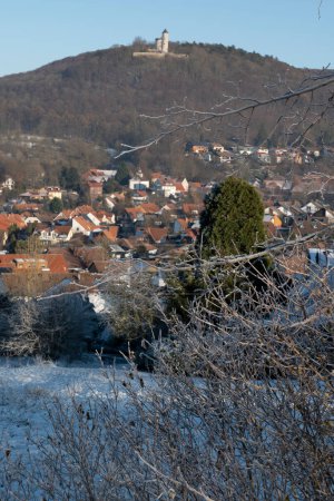 Photo for Eddigehausen in the snow with castle ruins Plesse castle. Winter landscape with village, fields, meadows and forest - Royalty Free Image
