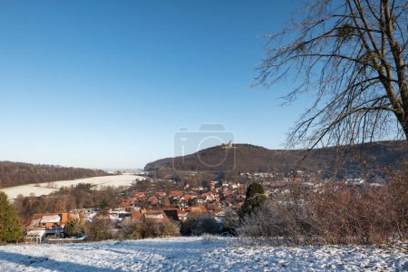 Photo for Eddigehausen in the snow with castle ruins Plesse castle. Winter landscape with village, fields, meadows and forest - Royalty Free Image